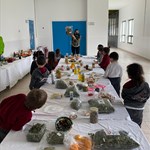 a group of people sitting at a table with a cake